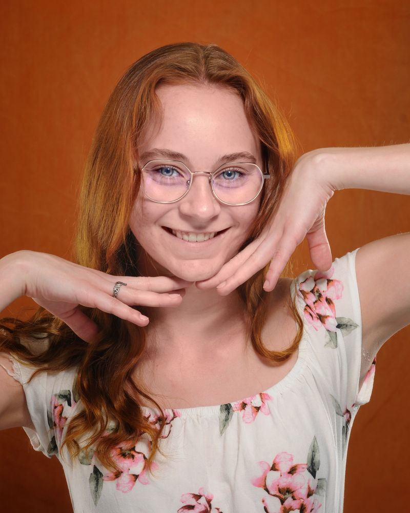 A smiling patient of The Optical Centre in thin metal frames